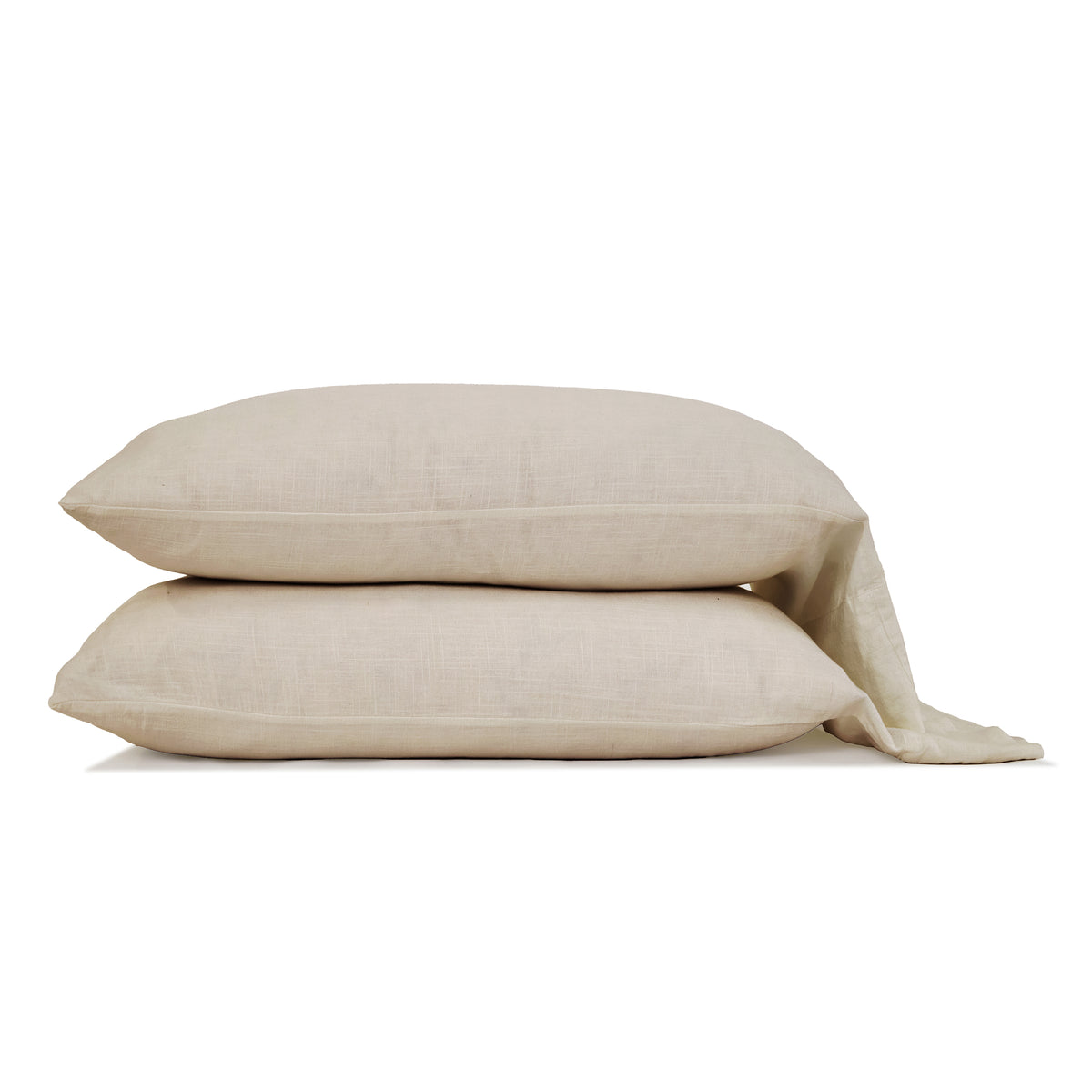 Natural bamboo linen sheet set with two folded pillows and draped coordinating sheet.