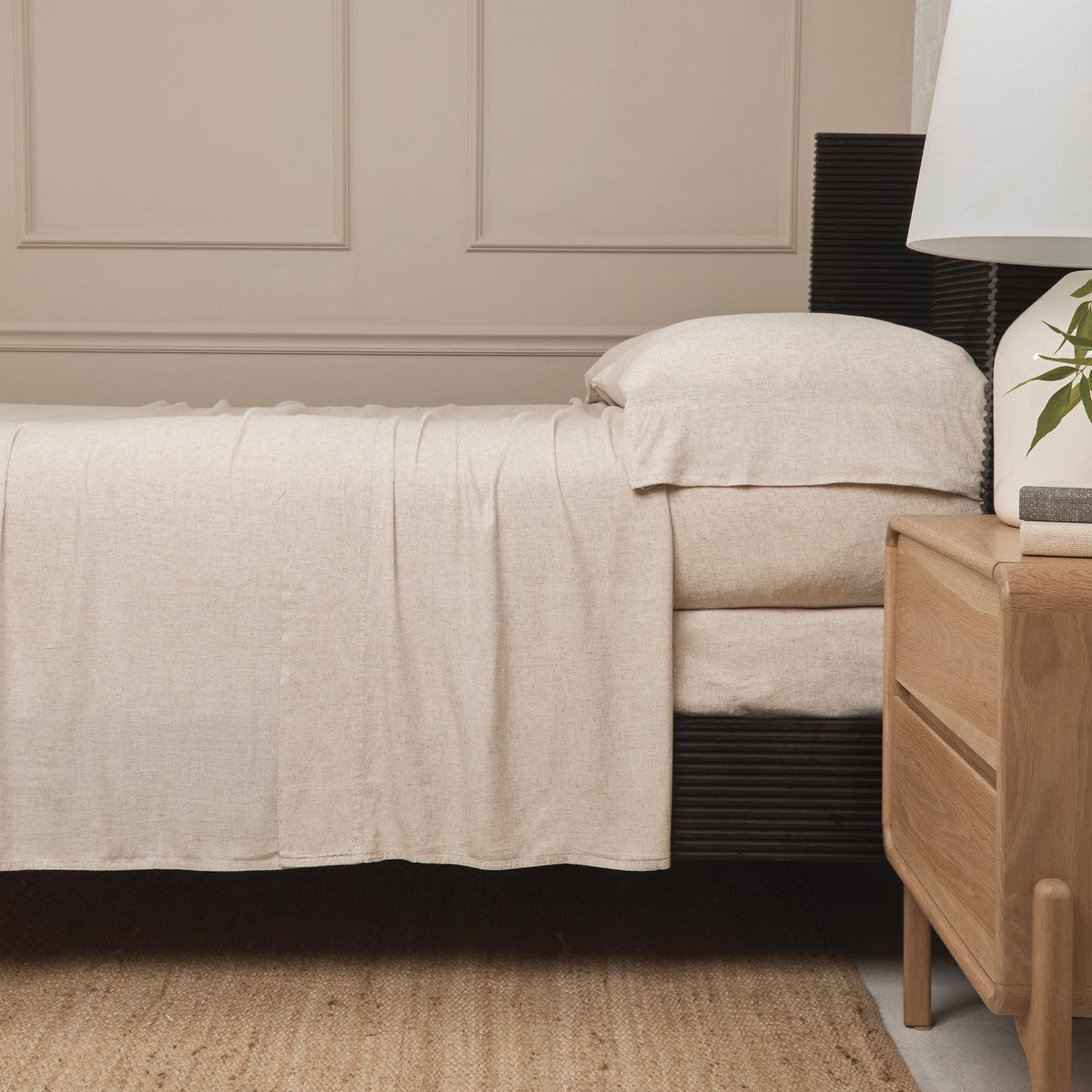 Natural bamboo linen sheet set on bed with fitted and flat sheets and pillowcases.