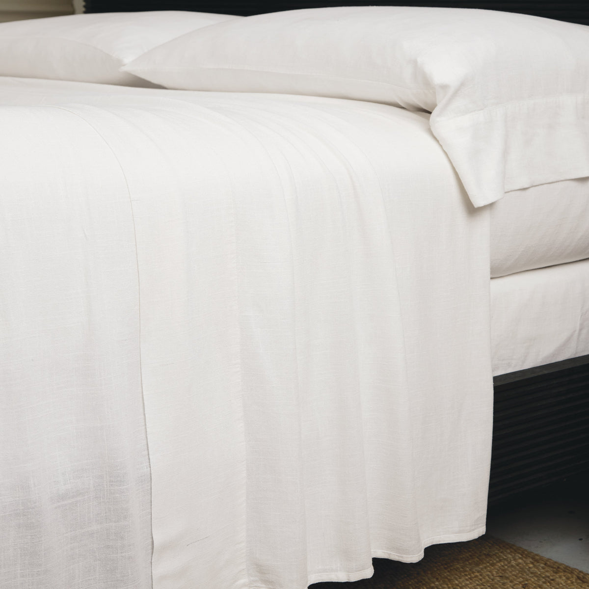 White bamboo linen sheet set showing fitted sheet and flat sheet folds with pillowcase.