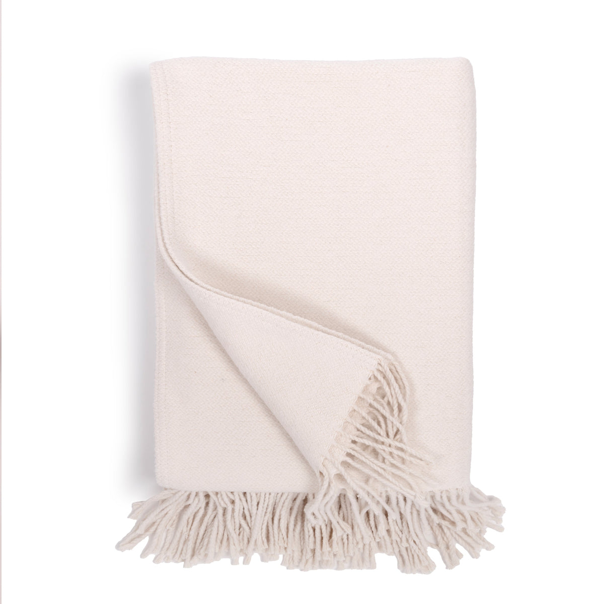 Billie blanket in ivory with fringed edges, folded throw fabric
