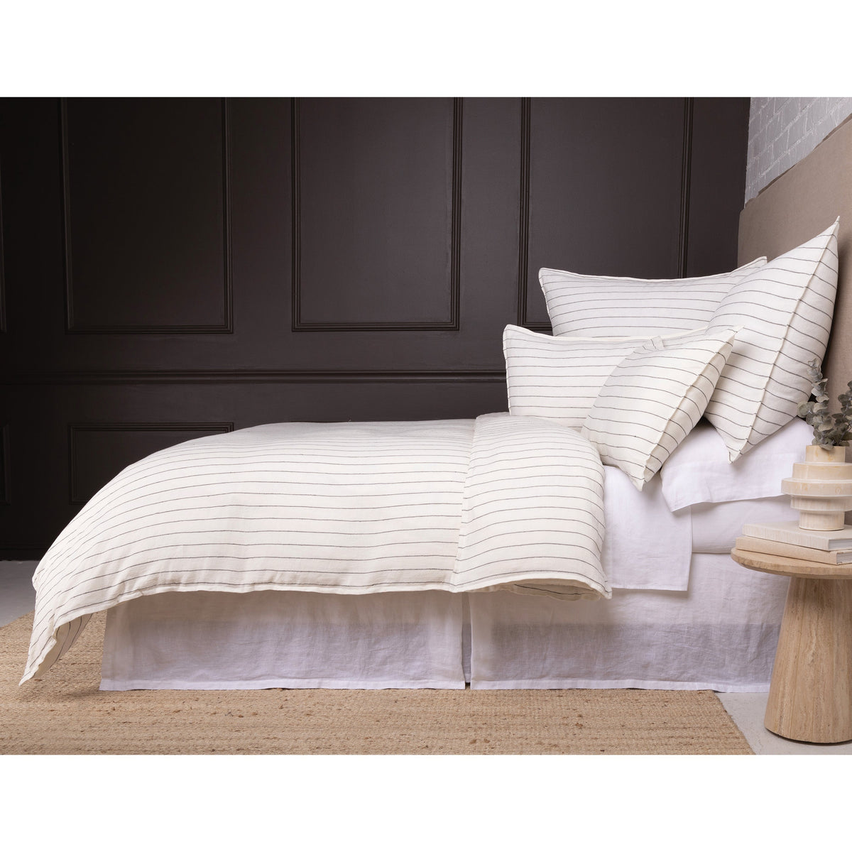 White duvet cover with fine horizontal stripes and layered white pillow shams