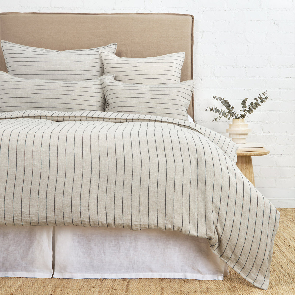 Striped duvet cover set with cream fabric and thin dark horizontal lines, with shams
