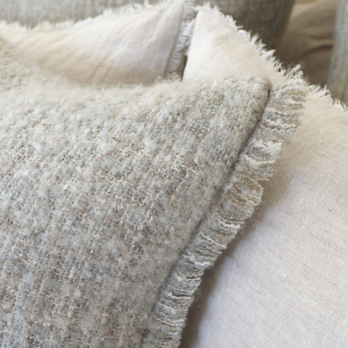 14x24 pillow with insert, light textured fabric with fringe and stitched corner