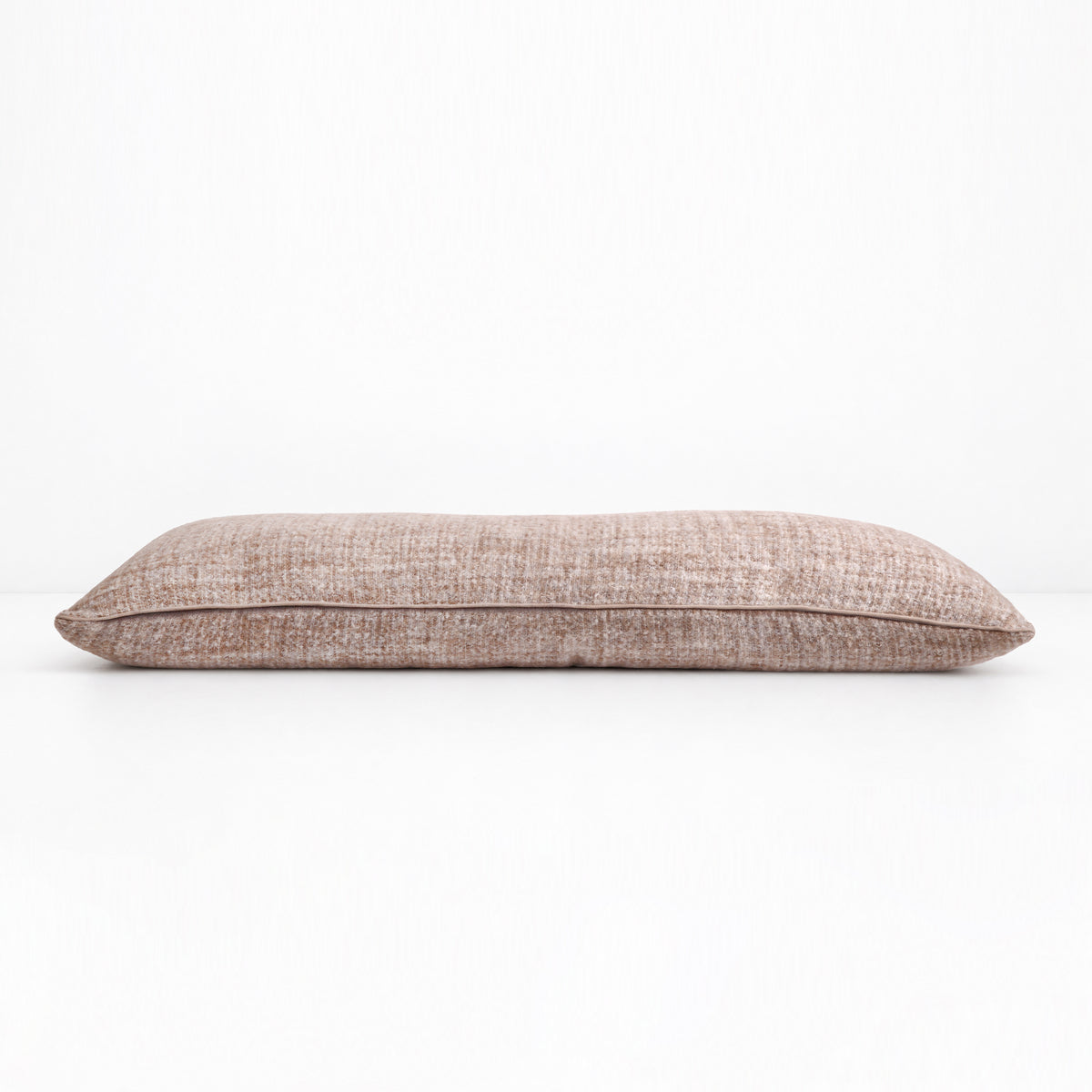18x60 body pillow in ivory shown from the side, with speckled fabric
