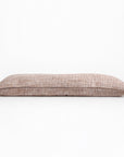 18x60 body pillow in ivory shown from the side, with speckled fabric