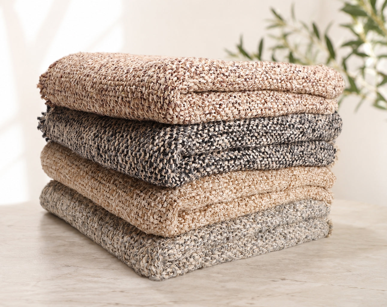 Brentwood woven throw blanket stack in natural, pebble and ocean tones, folded neatly
