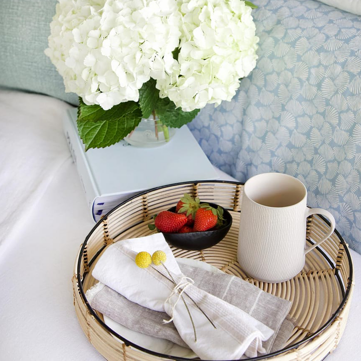 White napkin with light-gray striped border, tied in a bundle