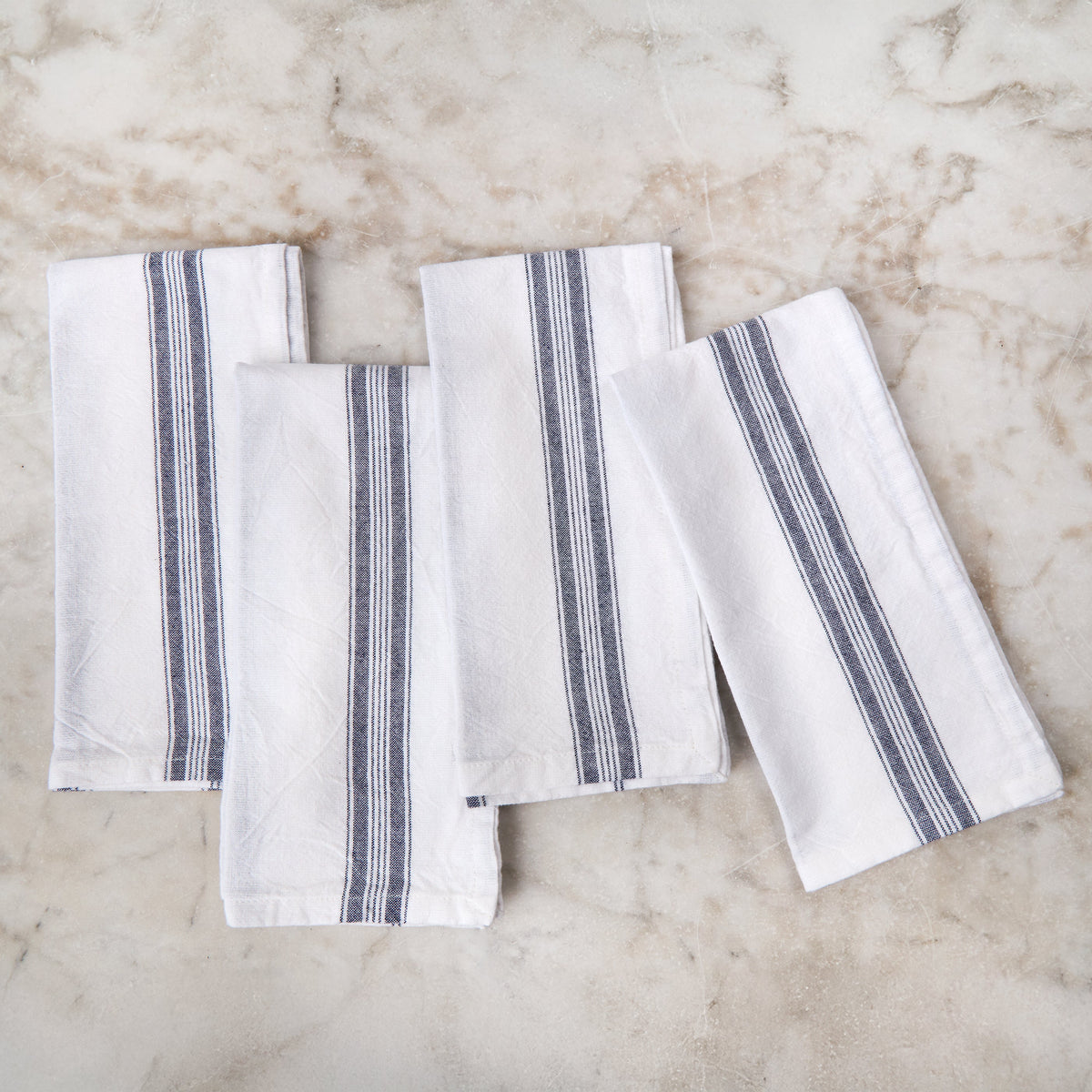Set of white napkins with navy vertical stripe borders
