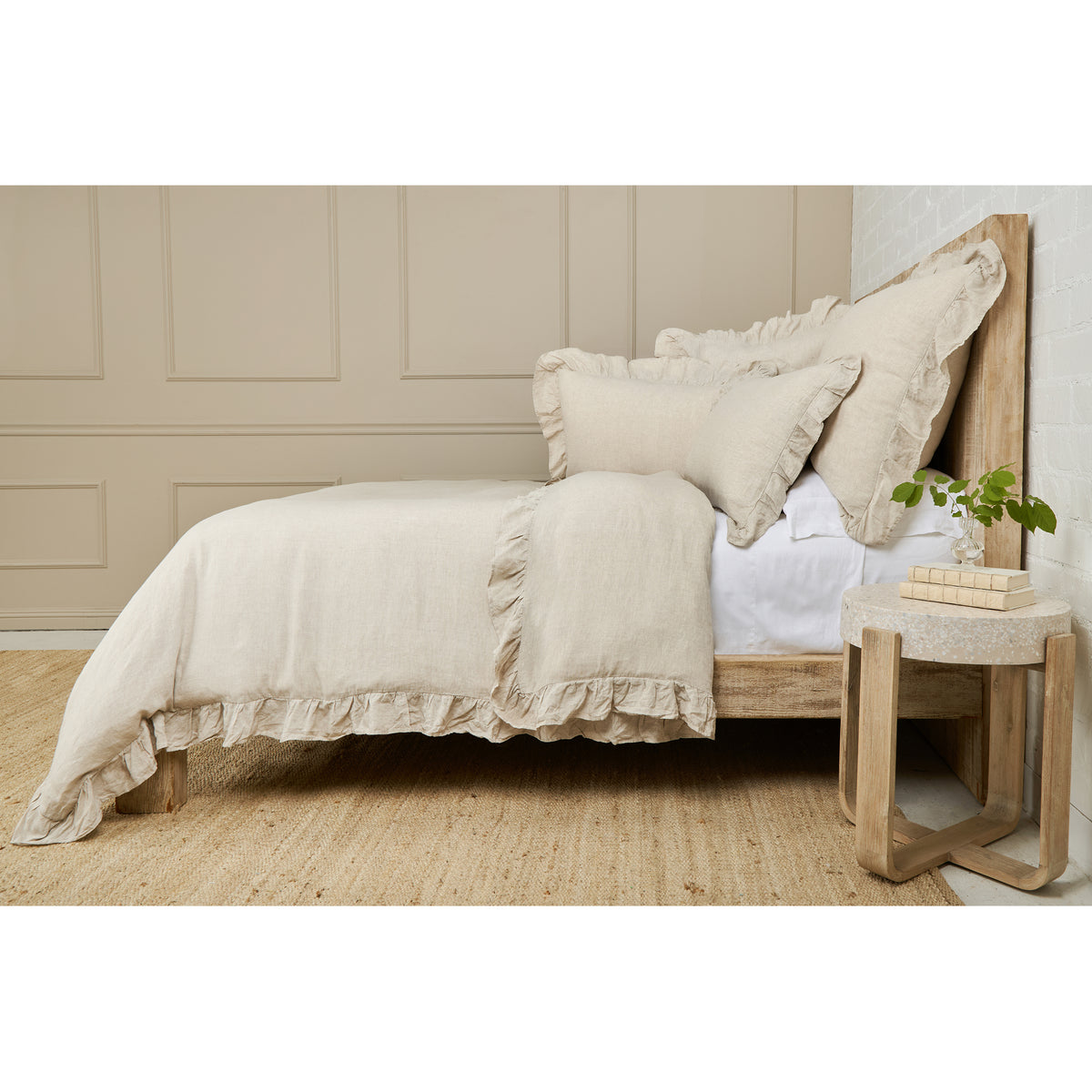 White duvet cover with ruffled trim and two decorative pillow shams