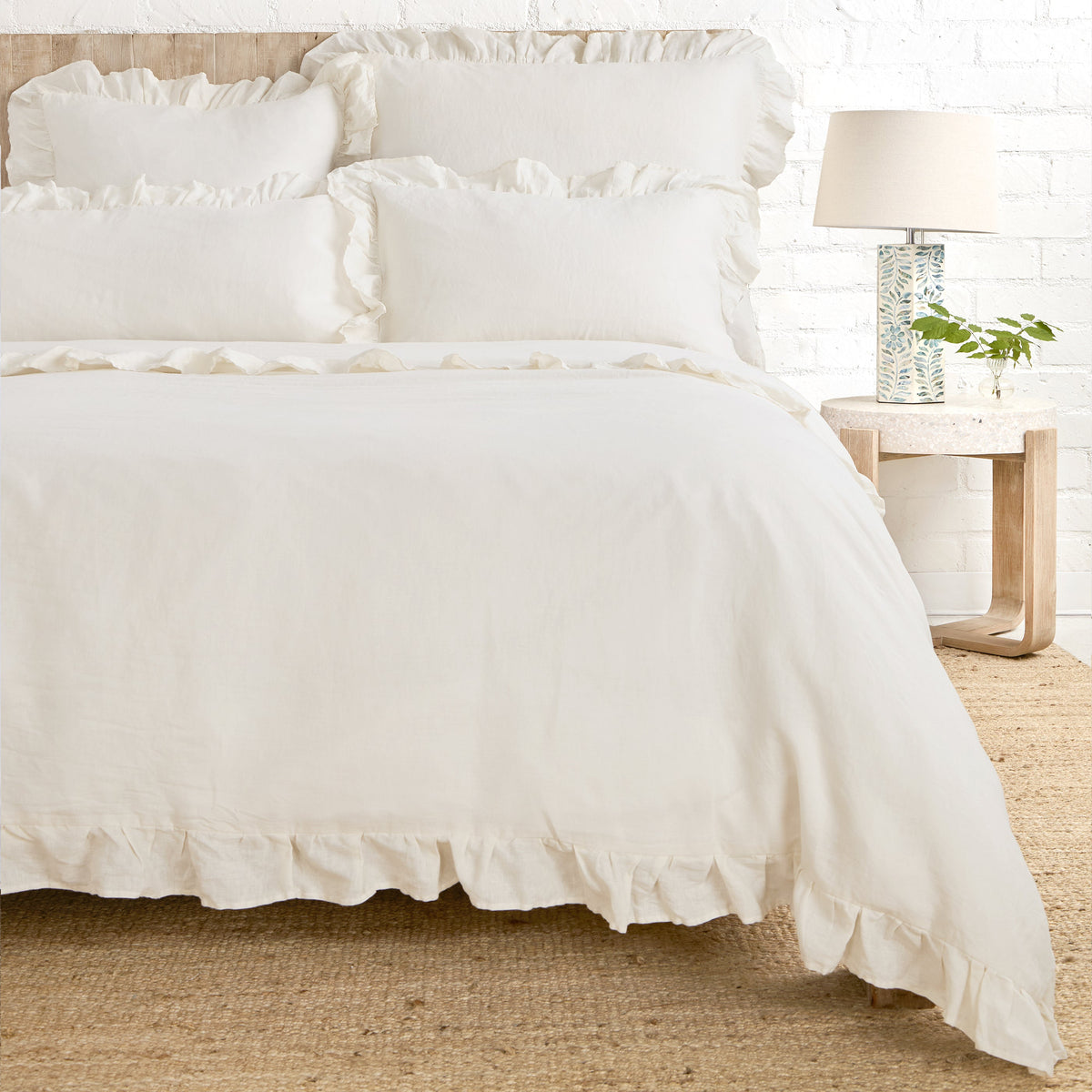 White duvet cover featuring gathered ruffle trim on the corners and edges