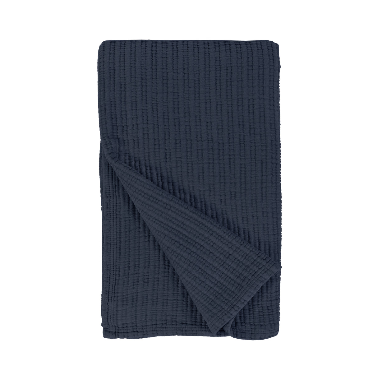 Oversized throw blanket in navy folded with textured woven pattern on a white background.