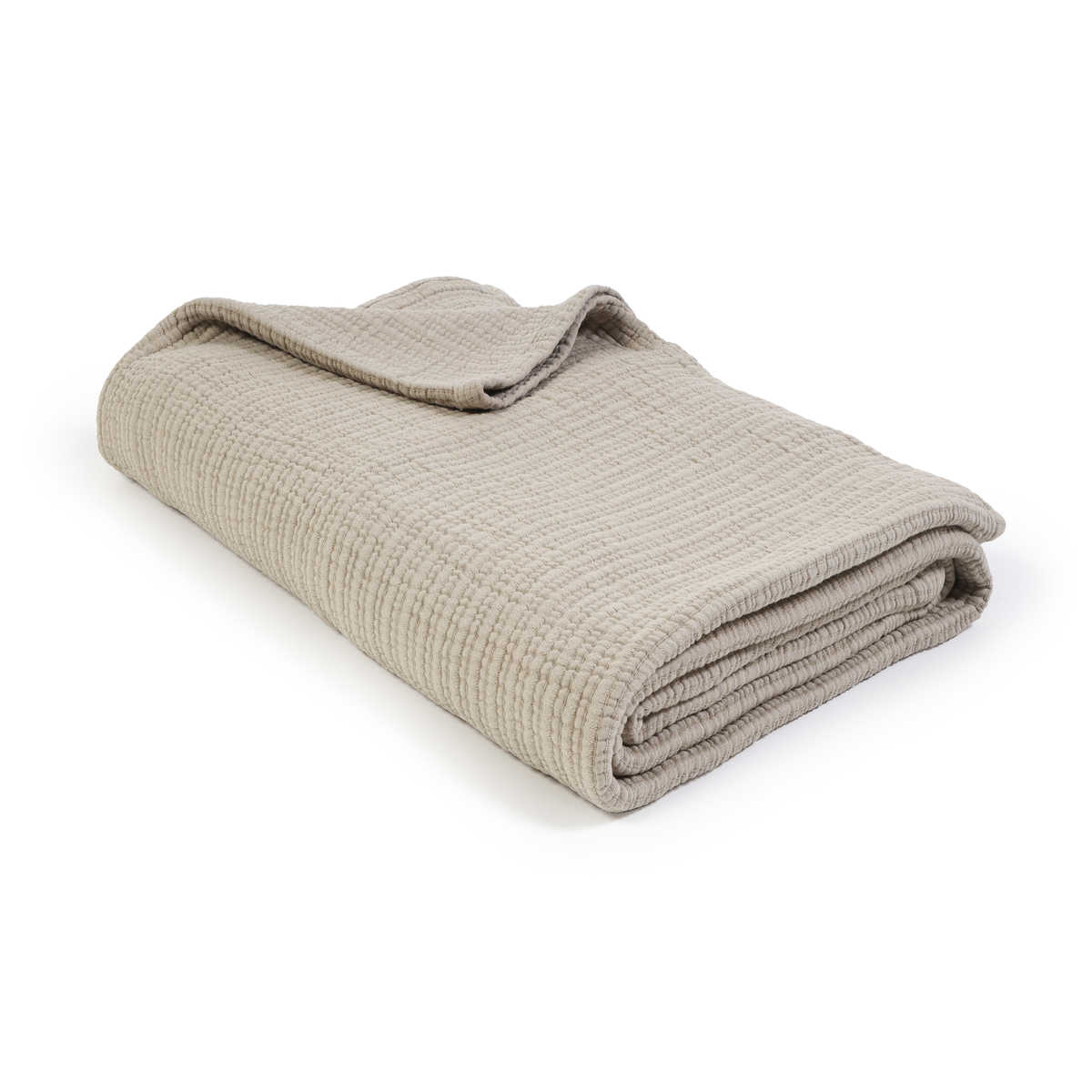 Oversized throw blanket in cream, folded with textured woven pattern.