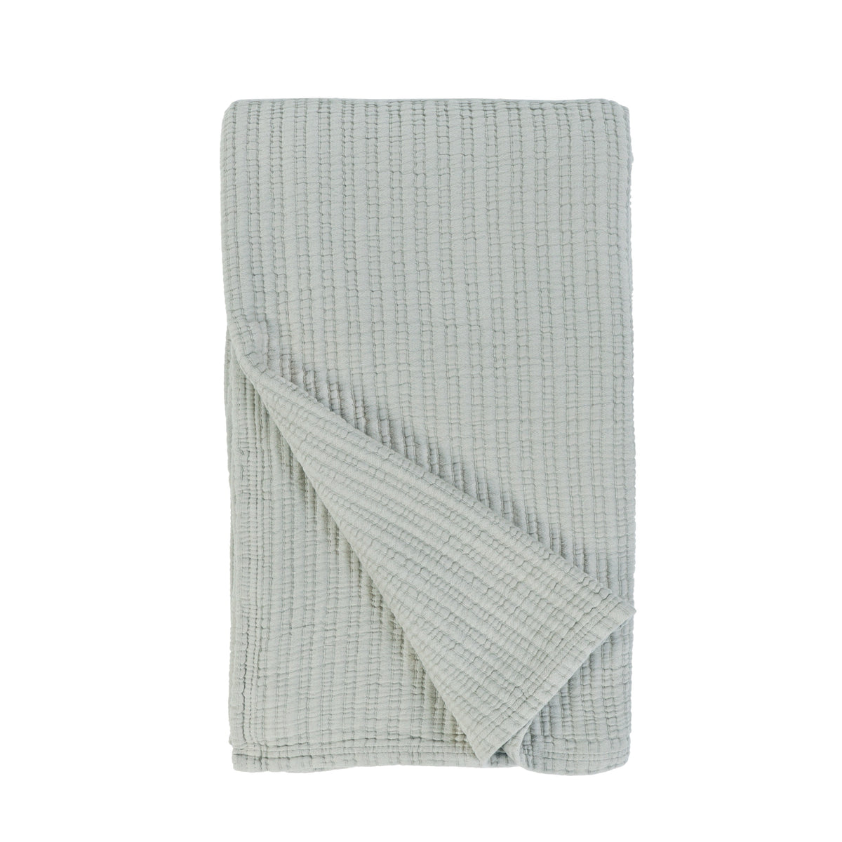 Sea glass textured throw with diagonal fold and waffle-knit surface