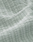 Sea glass throw close-up, waffle-knit texture with stitched ridges