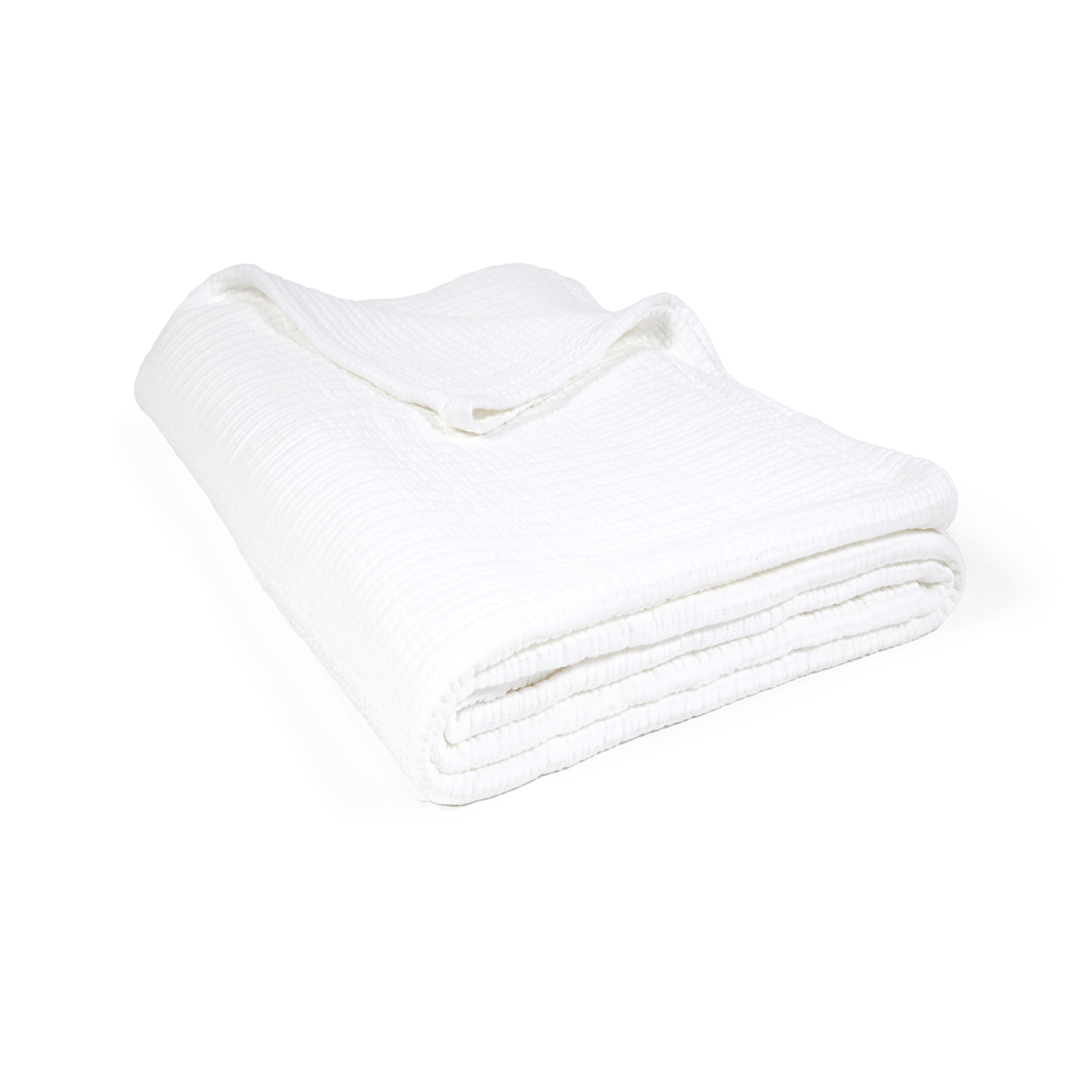 Oversized throw blanket in white folded, featuring textured woven surface.