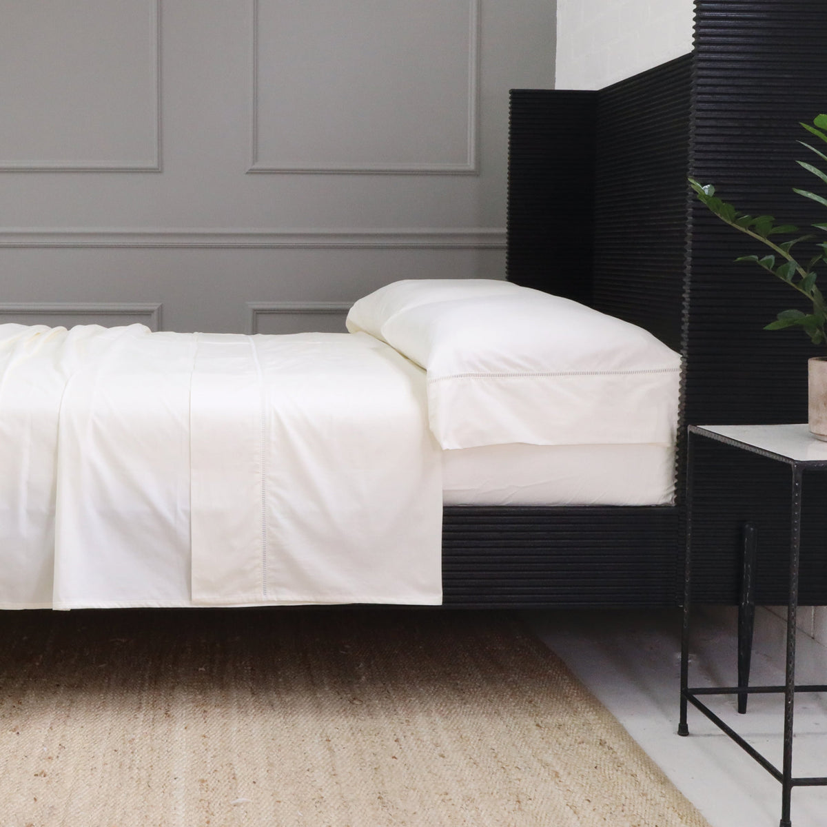 White cotton sateen sheet set with ladder-stitched border and fitted sheet edge detail