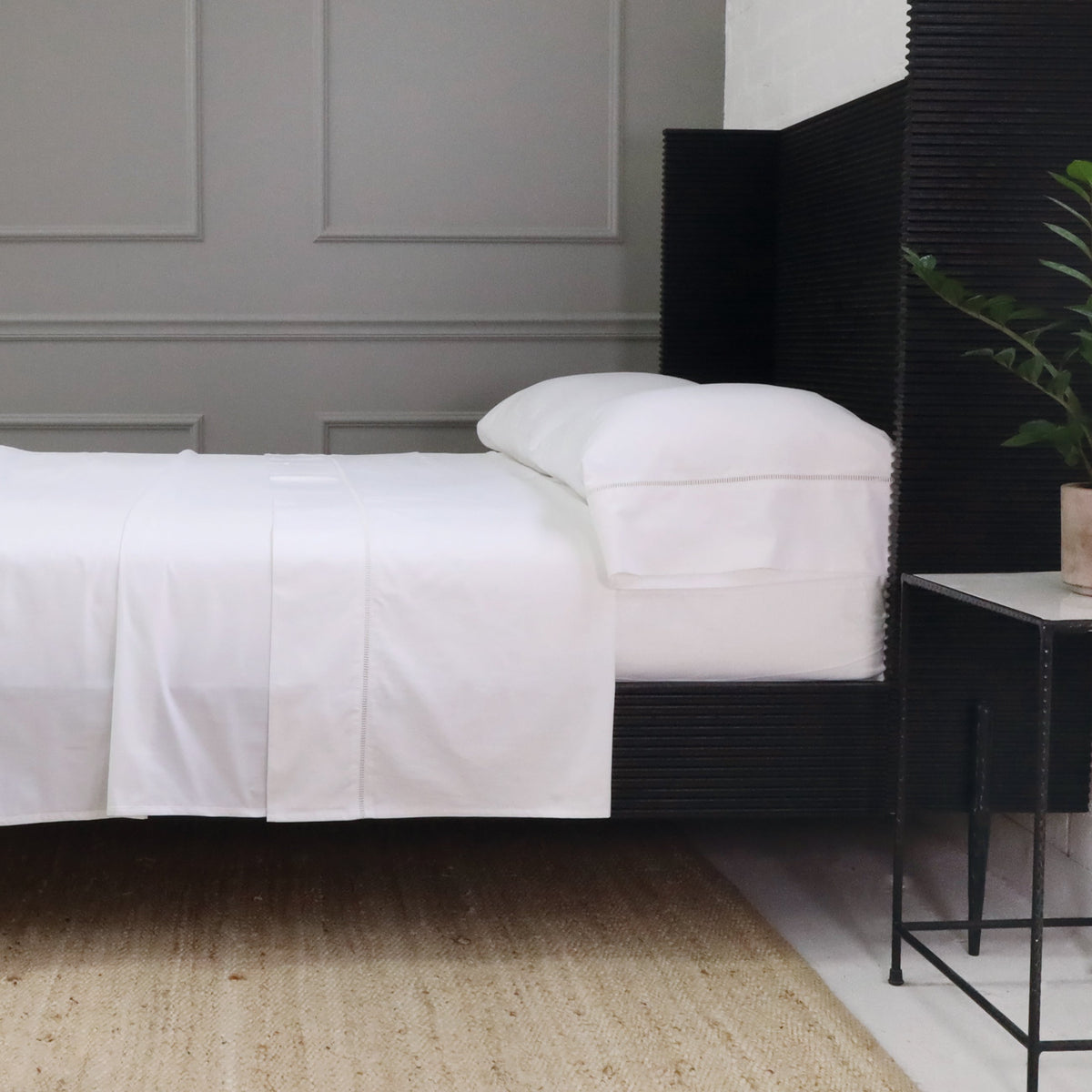 White cotton sateen sheet set with pillowcase and ladder-stitched trim along the edge