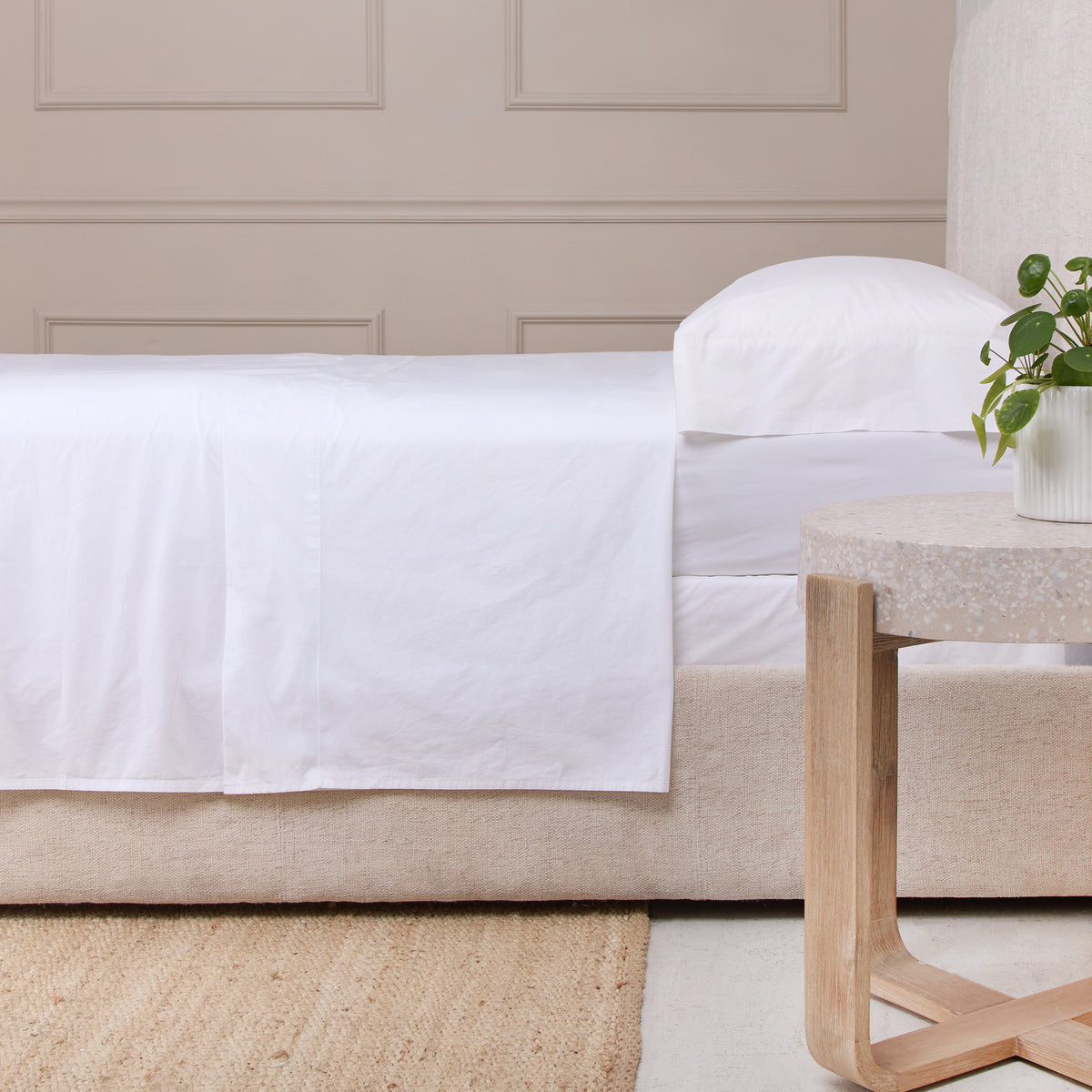 White cotton percale sheet set on bed with matching pillowcase