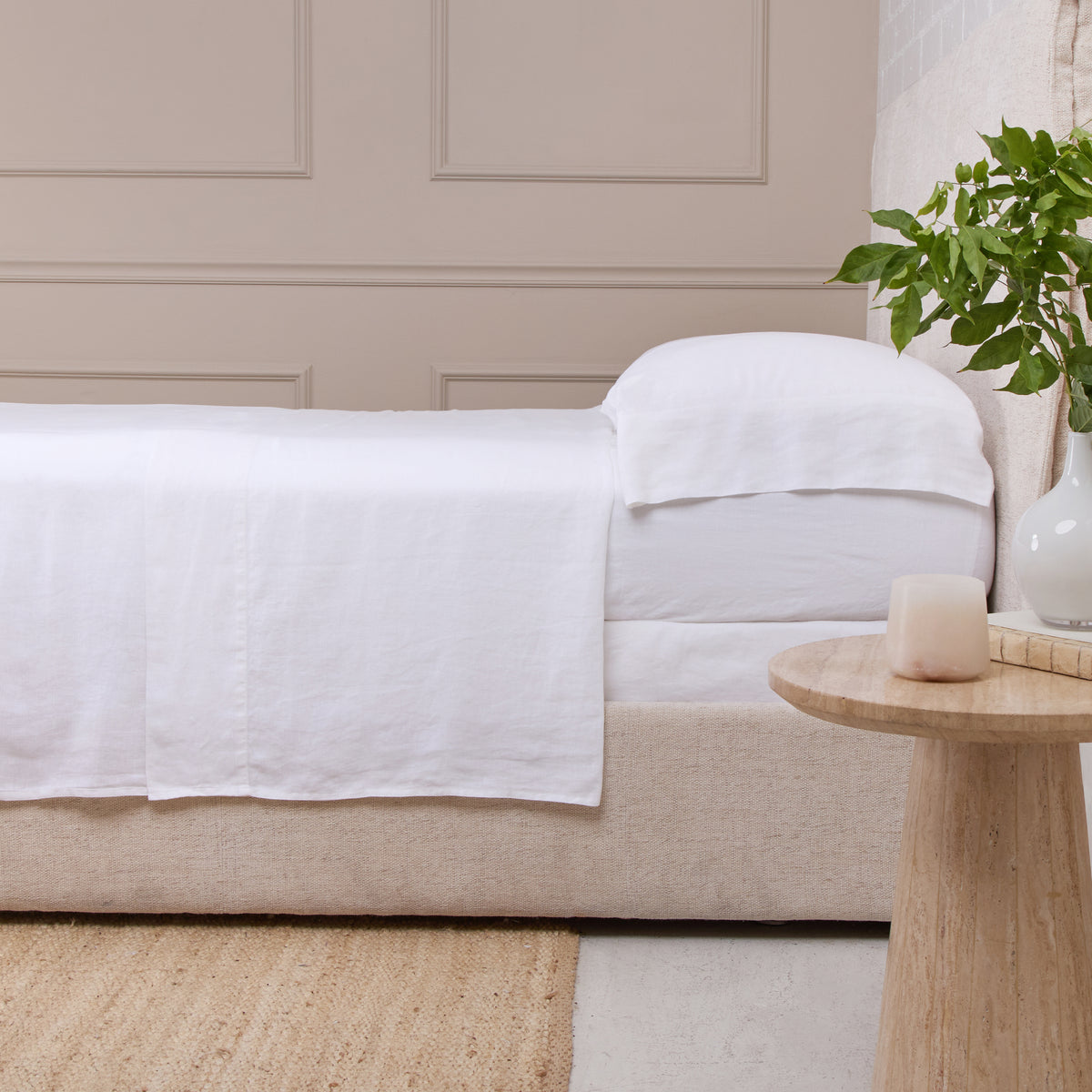 White linen sheet set on sofa, draped flat sheet with matching pillowcase
