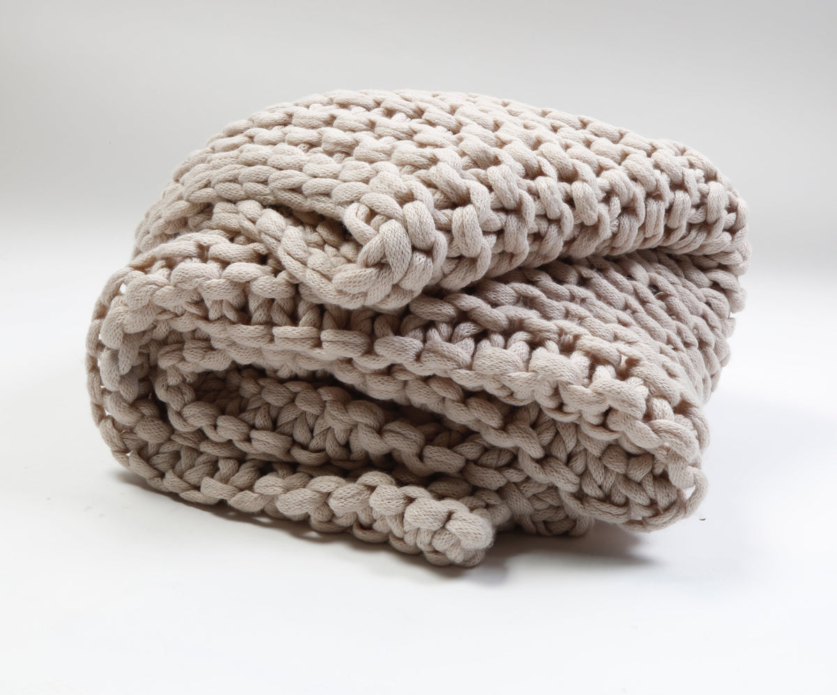 Taupe chunky knit throw blanket rolled up for display