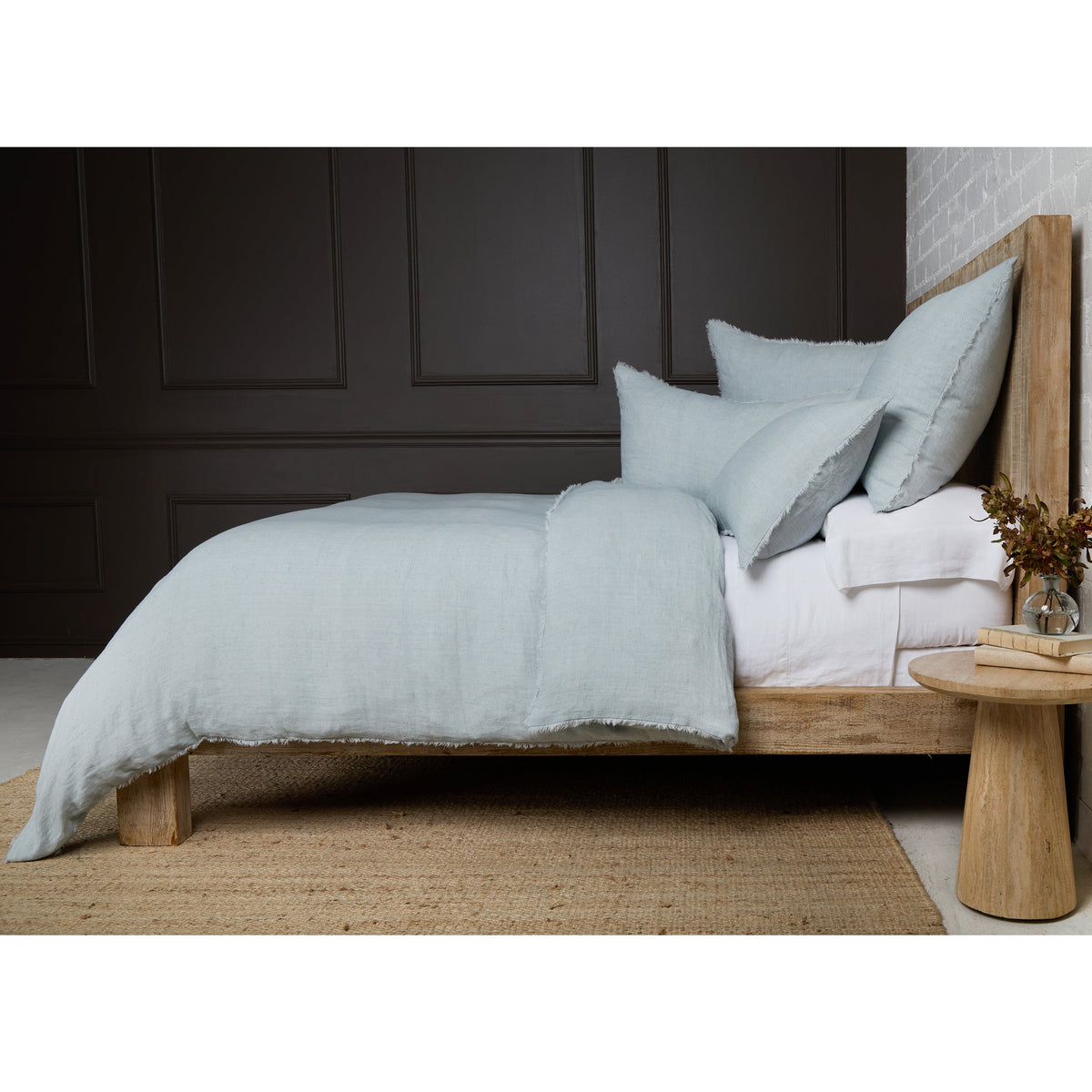 Light blue duvet cover with matching pillow shams, textured fabric and frayed edges
