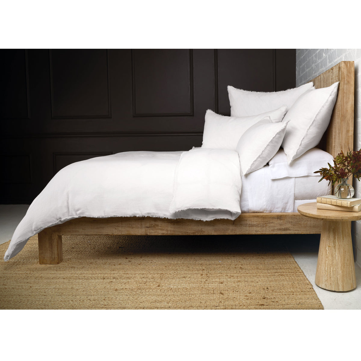 White duvet cover with matching pillow shams, frayed border in bed styling