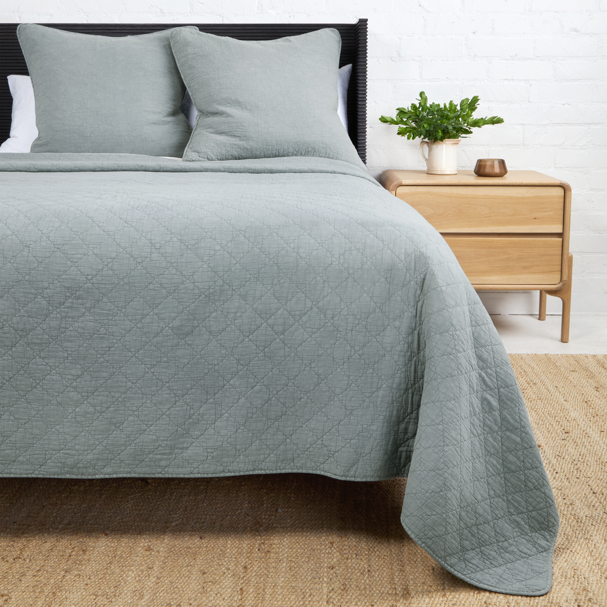 Dusty blue Huntington coverlet with diamond-quilt design and matching pillow shams.