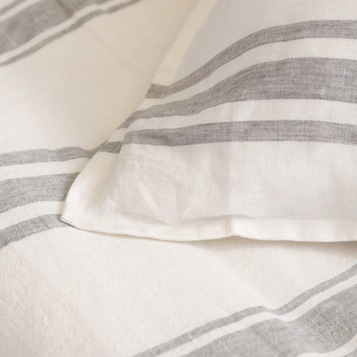 Jackson duvet cover fabric detail with white weave and gray striped bands, seam close-up