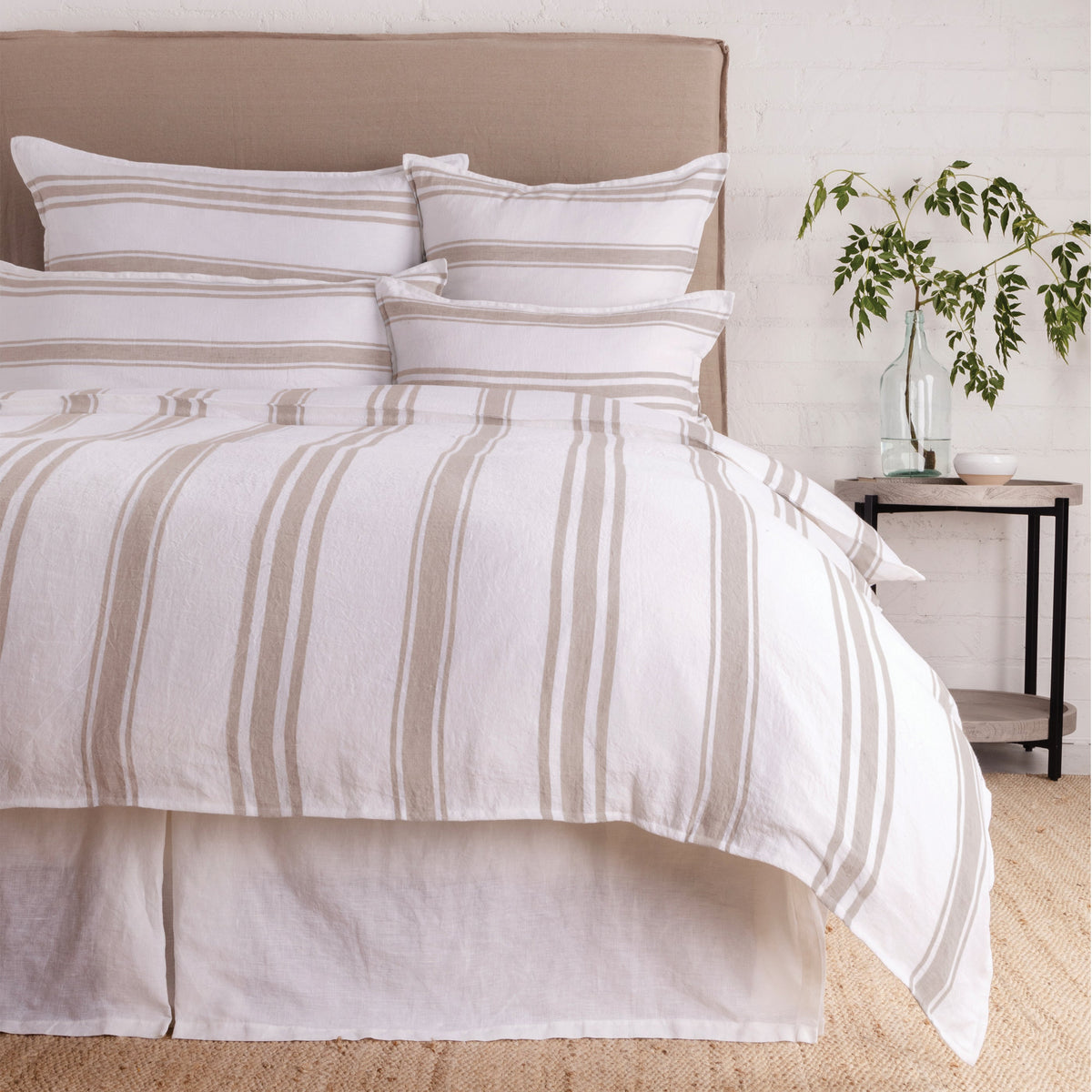 Duvet cover set in white with subtle light-gray stripes and matching pillow shams