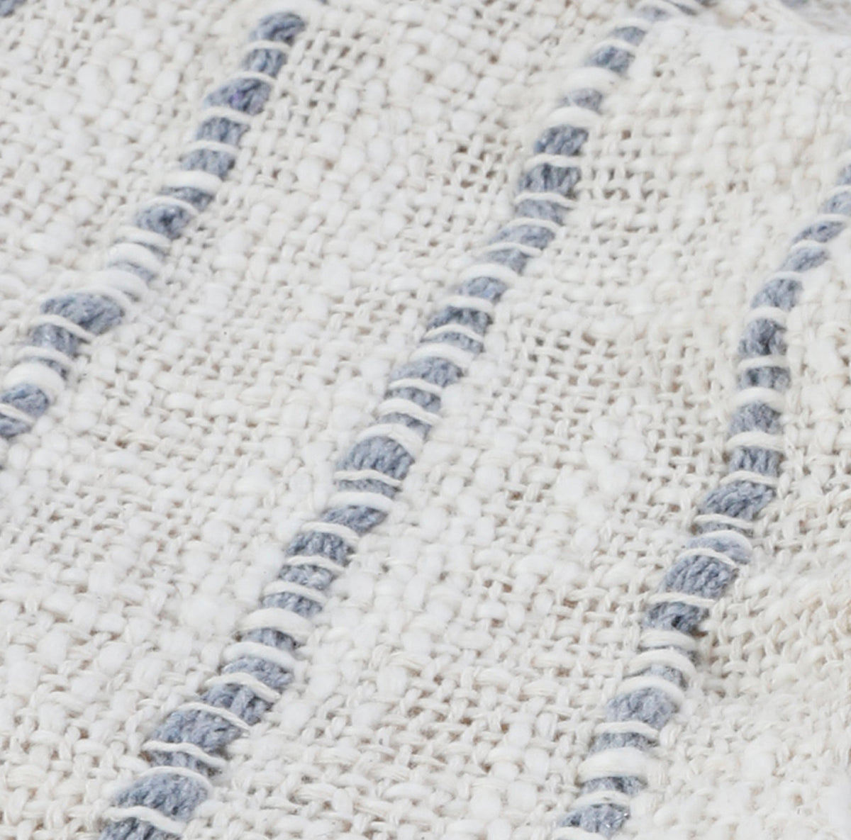 Close-up of 14x40 lumbar pillow fabric with ivory texture and blue-gray stitched stripes