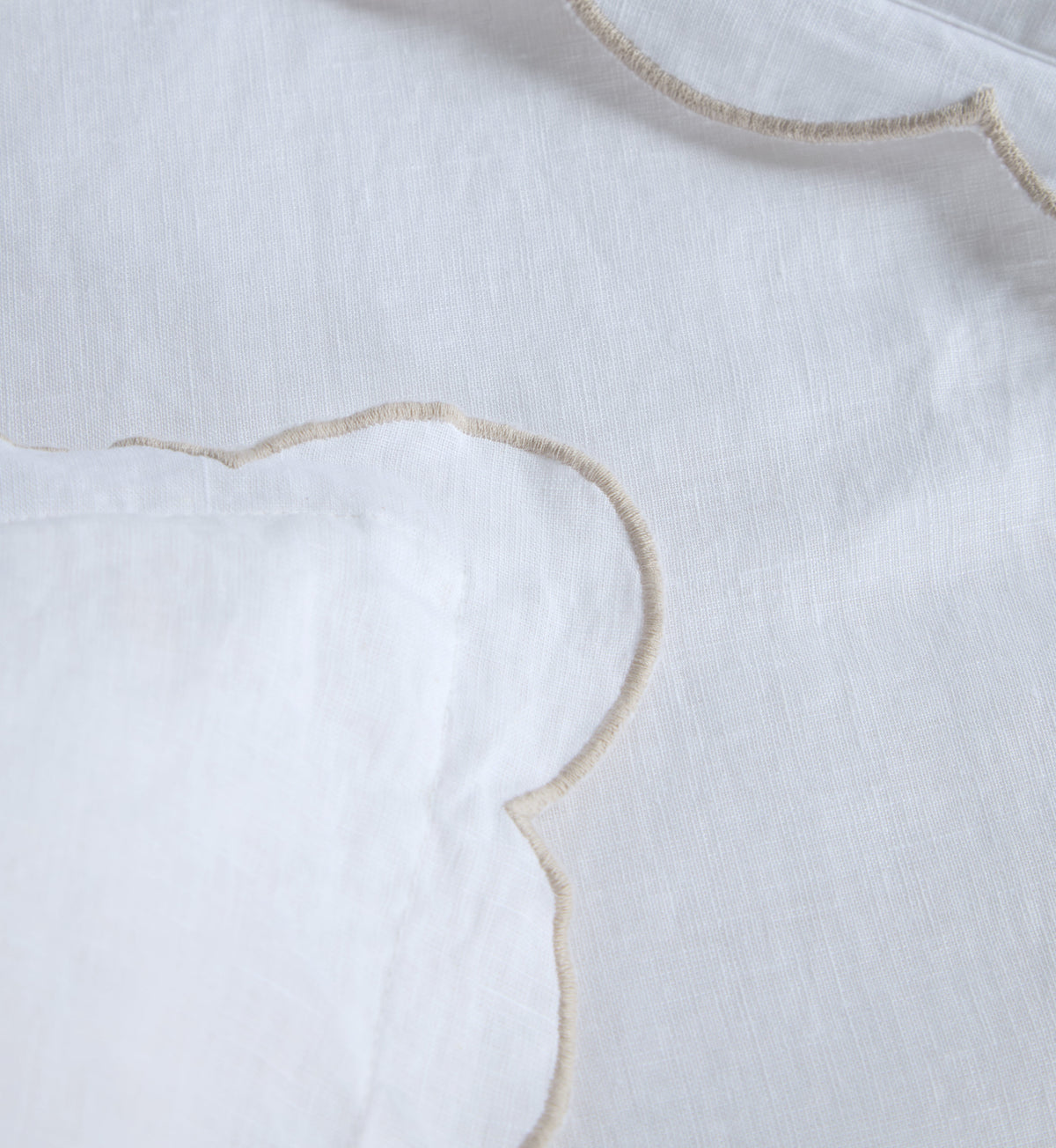 Kelly duvet cover fabric close-up with curved scalloped trim edging