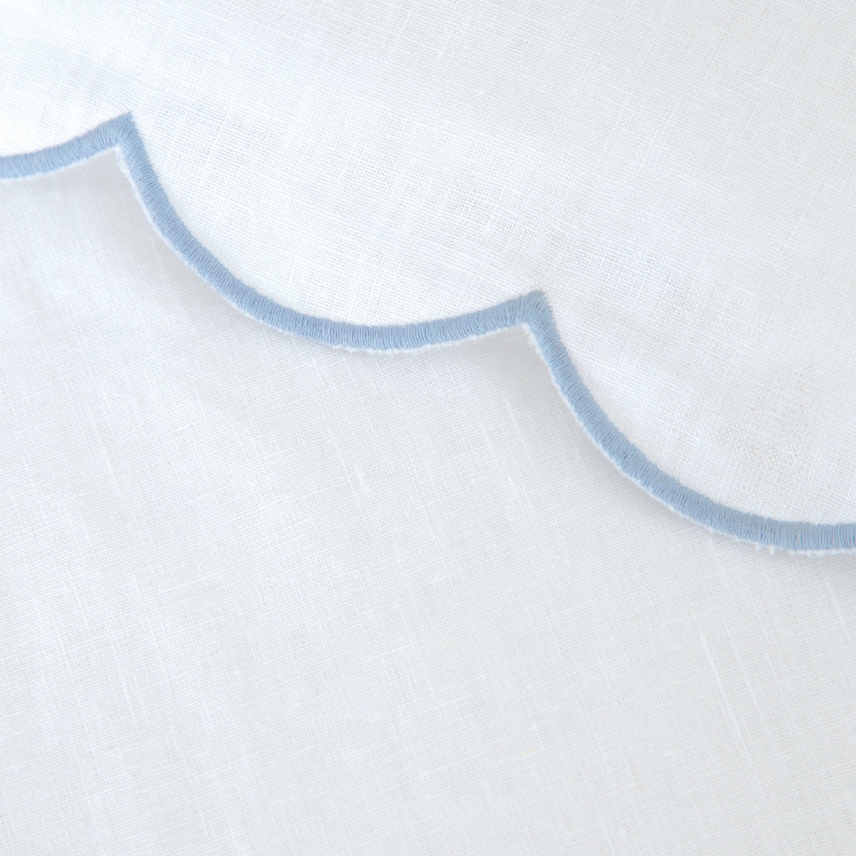 White linen pillowcase with light blue scalloped trim