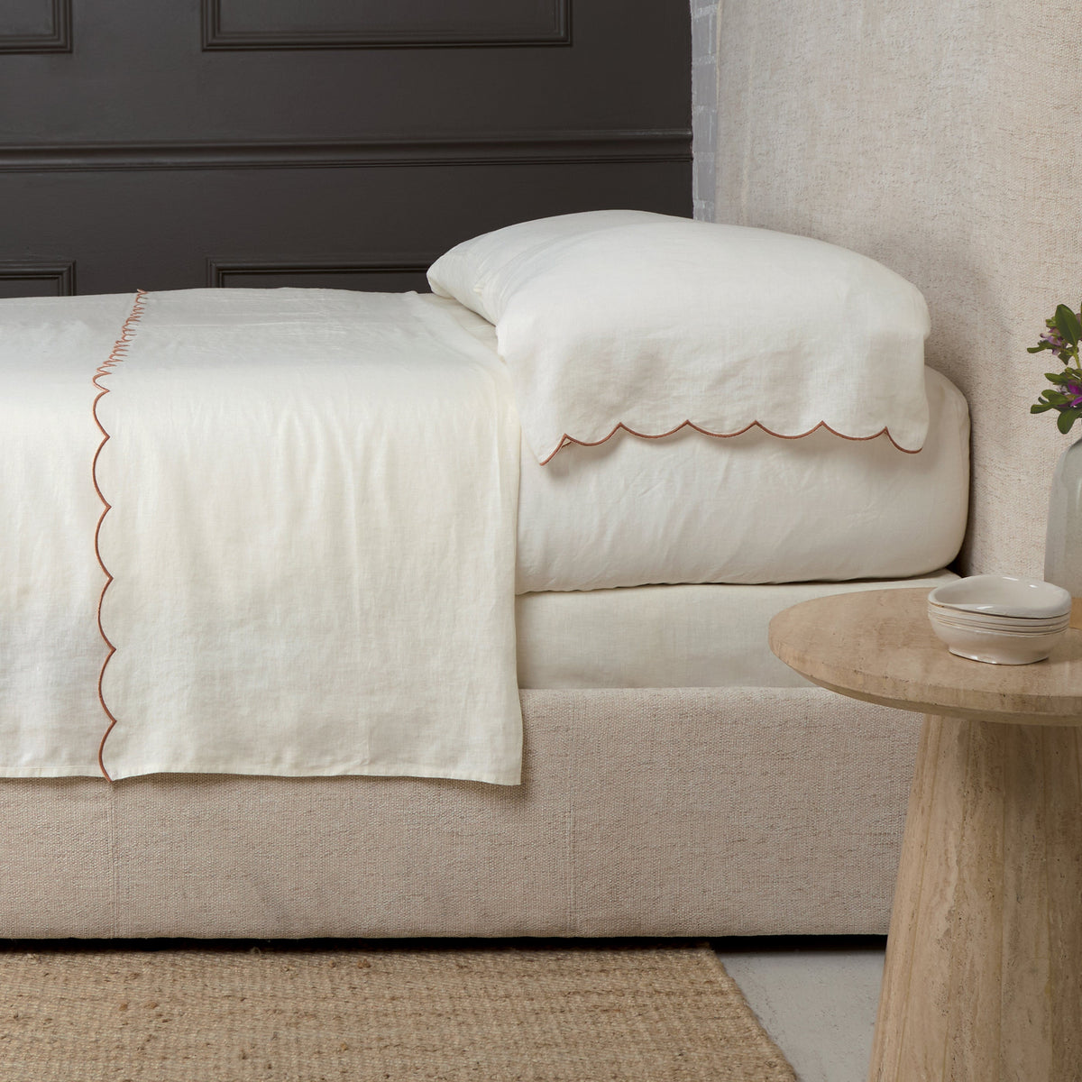 Cream linen sheet set with terracotta scalloped edge trim
