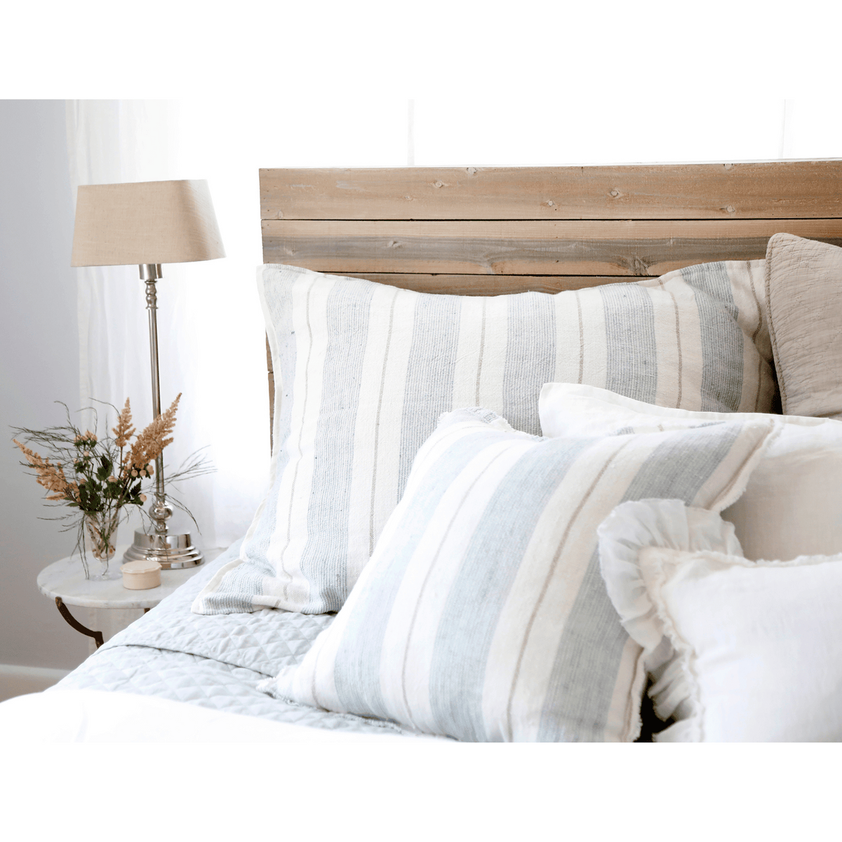 28x36 striped pillow with insert on bed, off-white and light gray vertical stripes