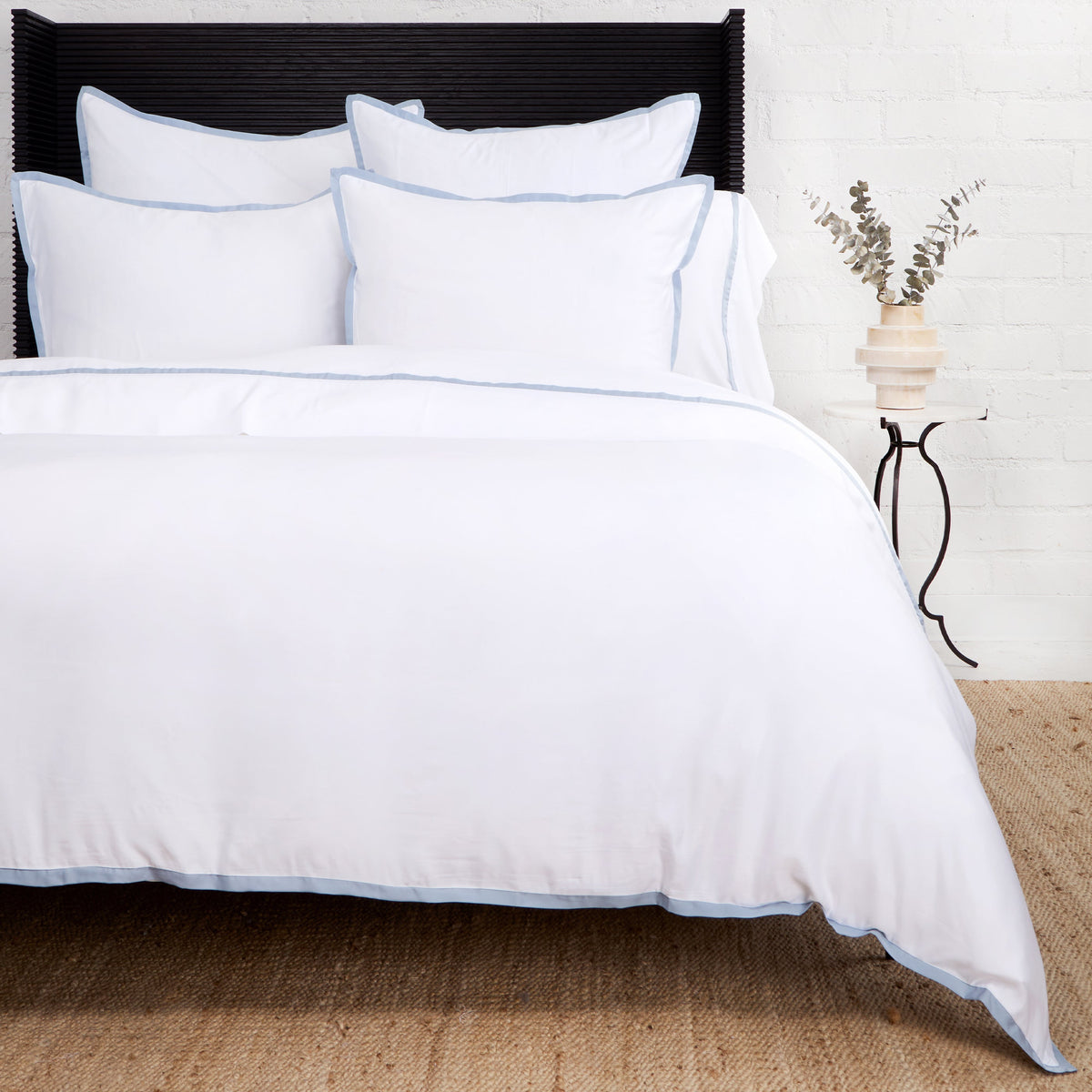 Bamboo sateen duvet cover set in white with blue piped trim and matching shams