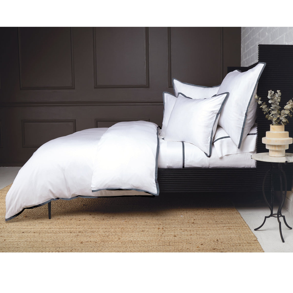 Bamboo sateen duvet cover set in white with dark piped trim and layered shams