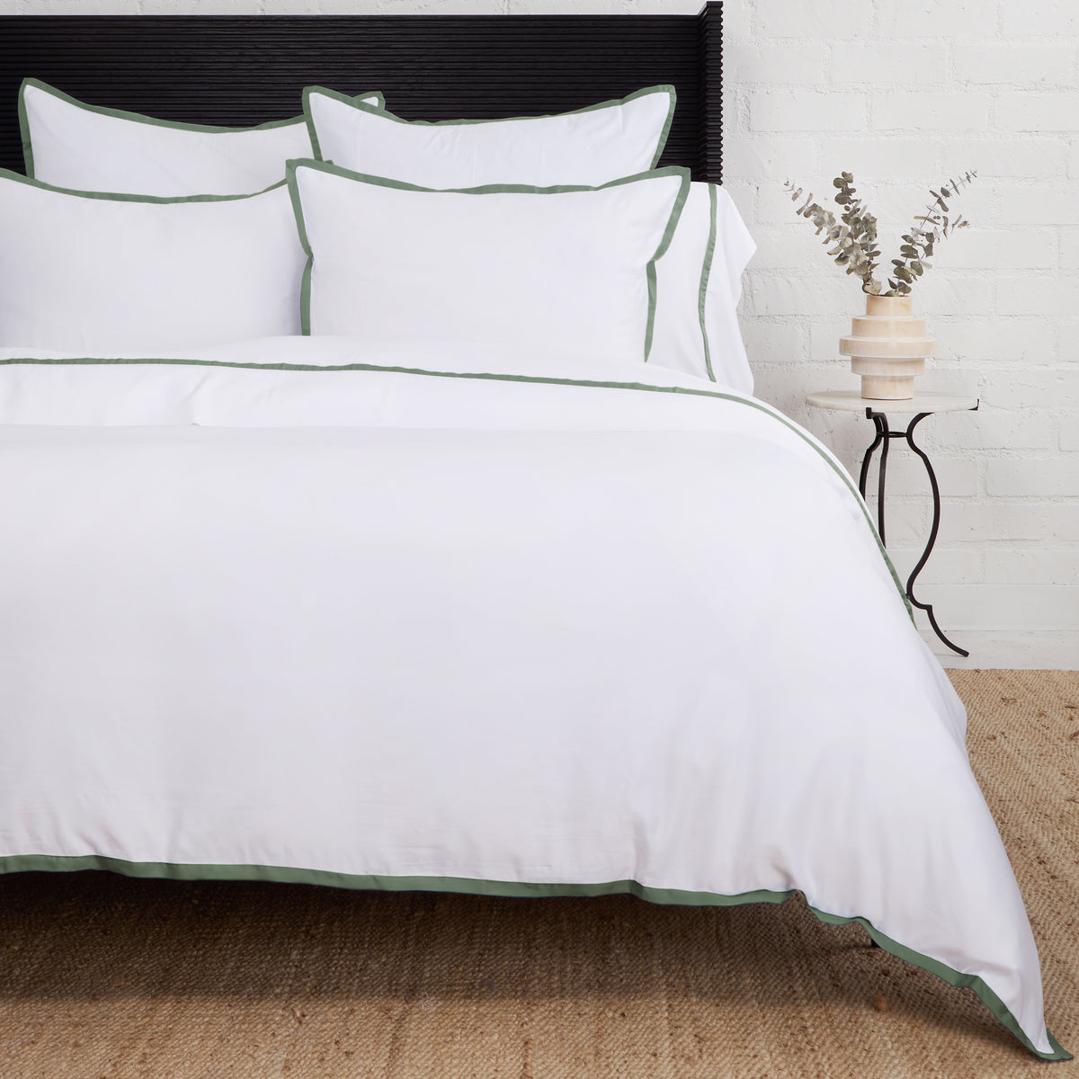 Bamboo sateen duvet cover set in white with green piped trim and matching shams