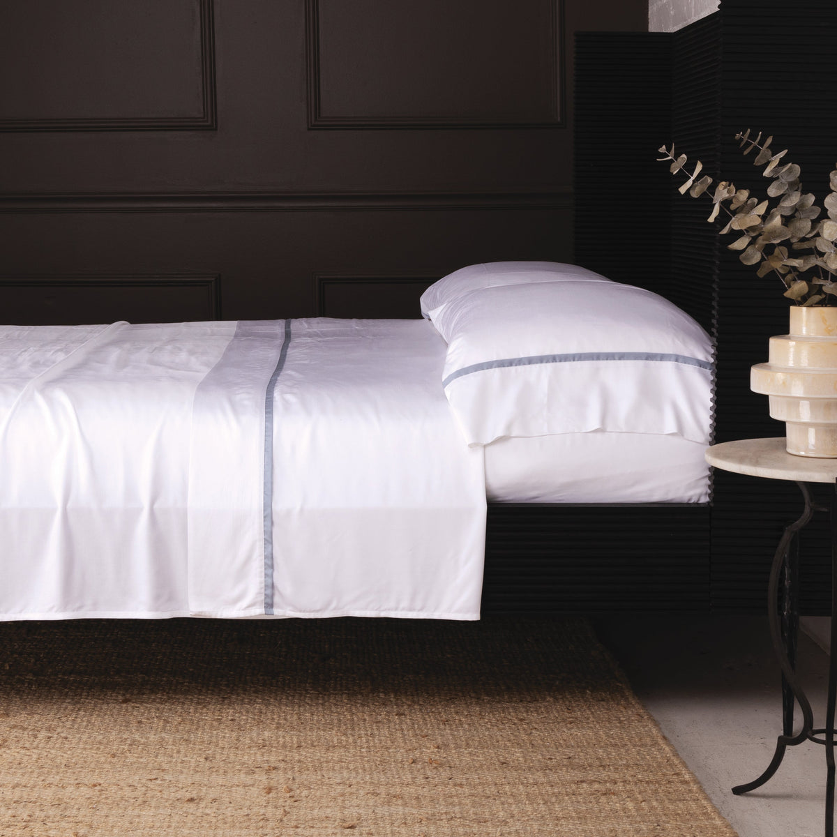 White bamboo sateen sheet set with dark-trim border and matching pillowcase on bed