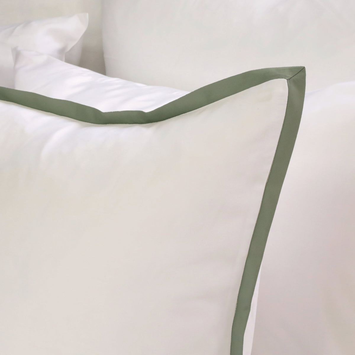 Bamboo sateen duvet cover corner in white with moss green edge trim