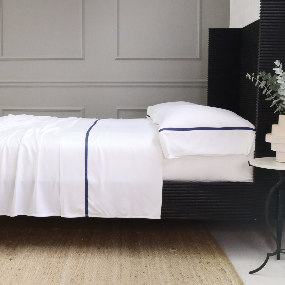 White bamboo sateen sheet set with navy stripe detail on fitted sheet edge