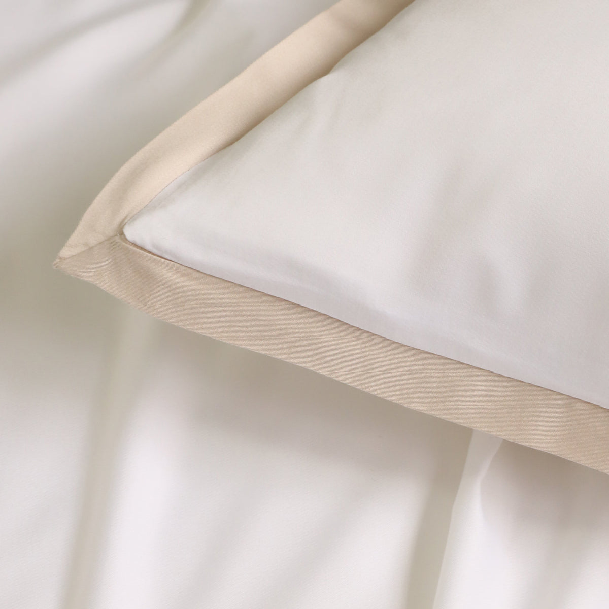 White duvet cover with light tan trim and folded corner detail