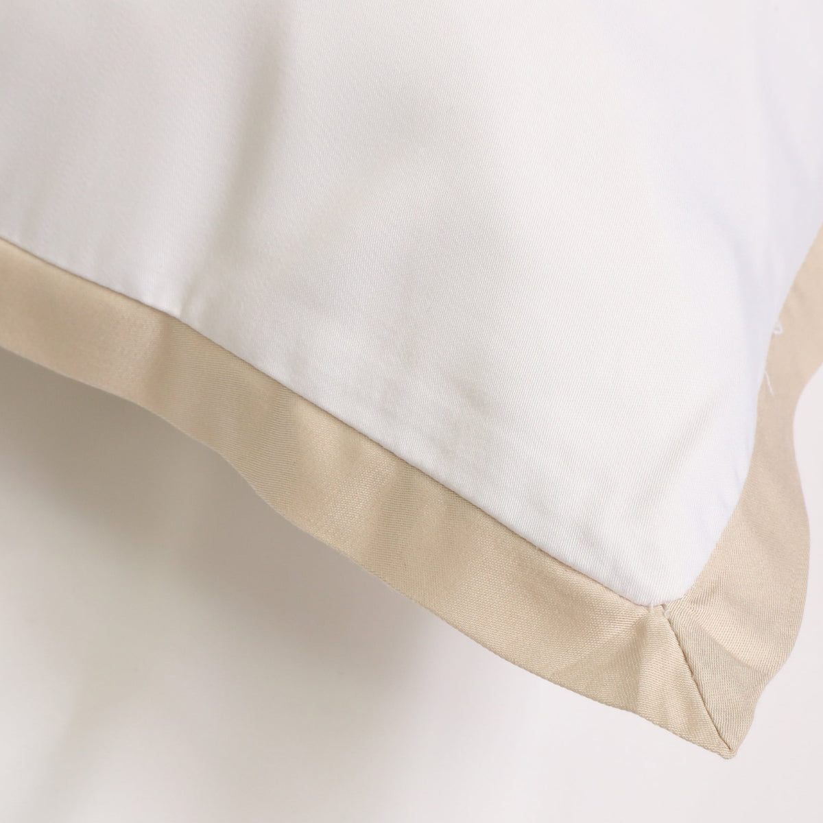 White duvet cover sham with tan border trim along the edge