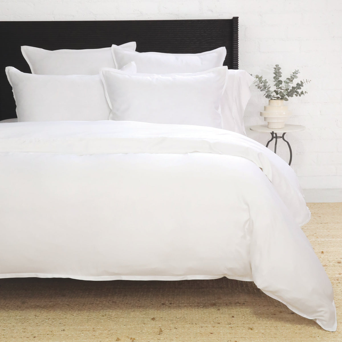 White duvet cover set with navy trim and multiple matching shams