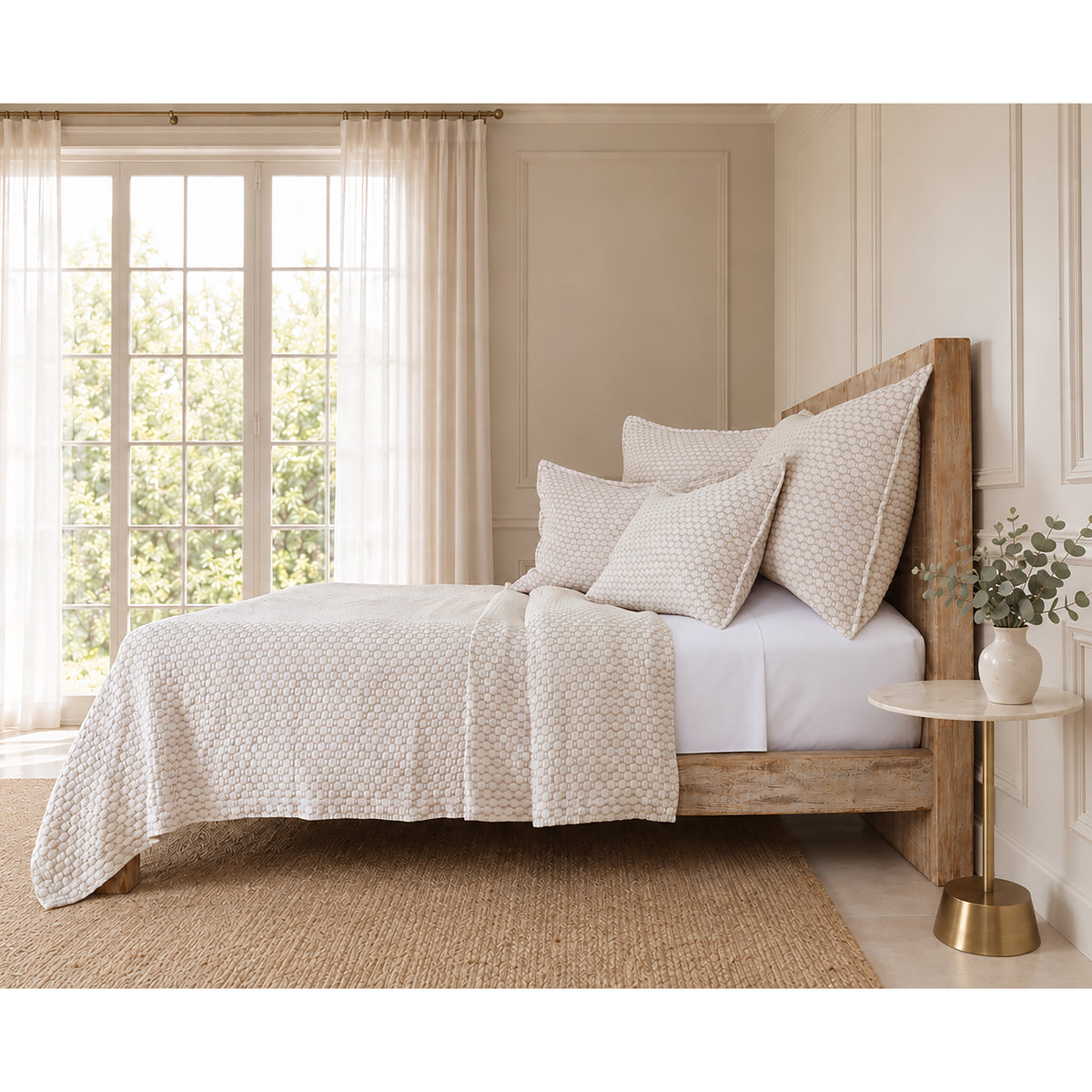 Matelasse quilt and pillow shams bedding set in light oatmeal on a bed