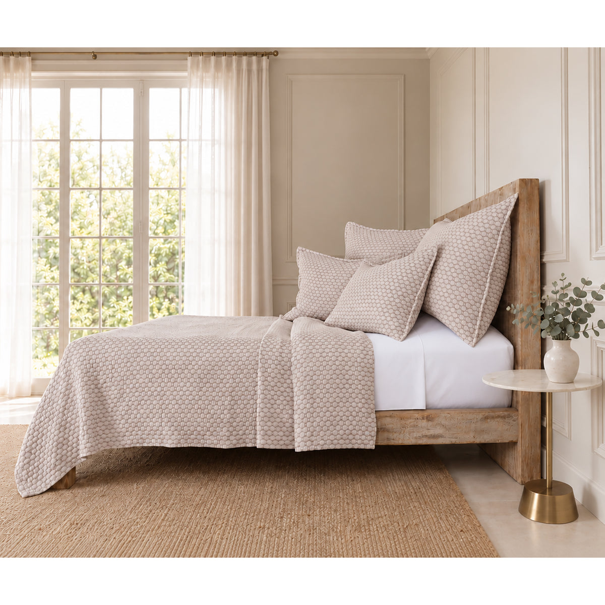 Matelasse quilt and pillow shams bedding set in light oatmeal on a bed