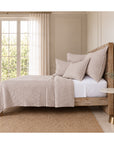 Matelasse quilt and pillow shams bedding set in light oatmeal on a bed