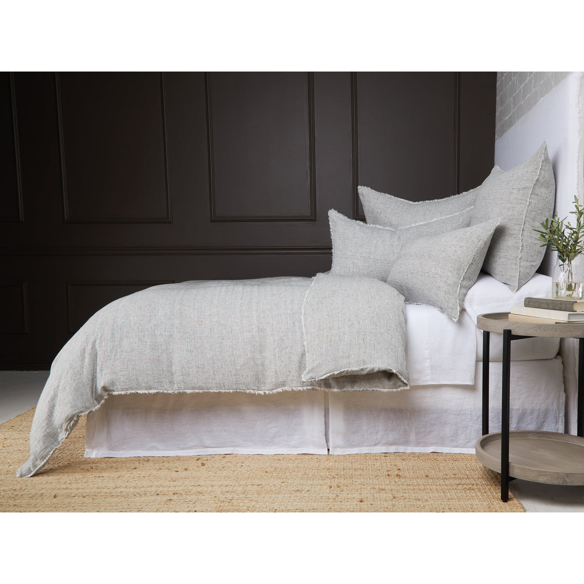 Light gray textured duvet cover set with fringed edge and matching pillow shams