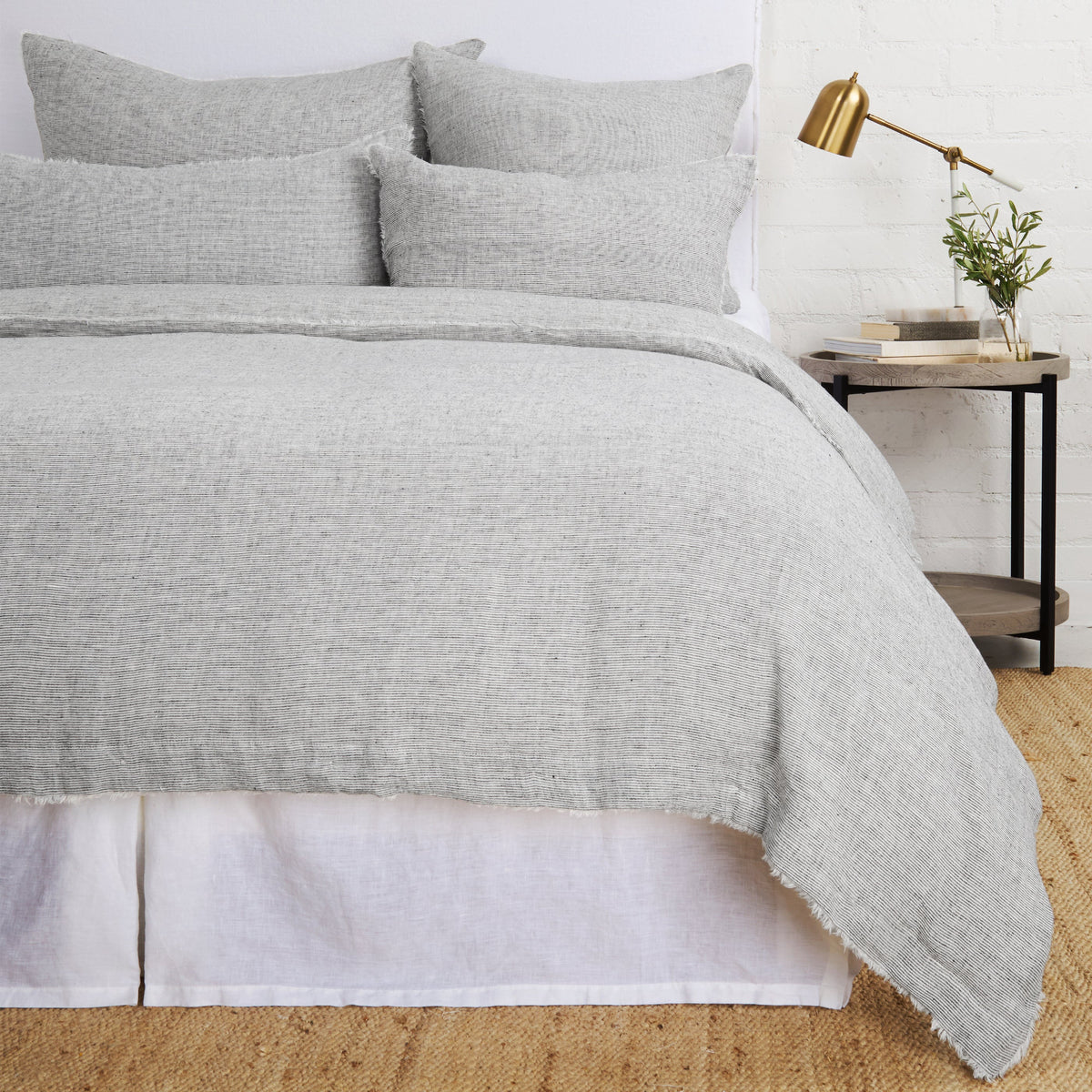 Charcoal gray textured duvet cover with soft fringe trim and matching pillow shams