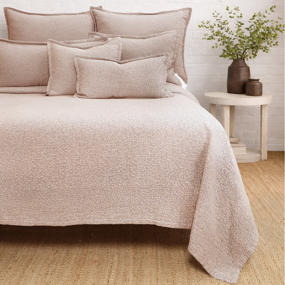 Washed terra cotta matelasse quilt with matching pillow shams and textured surface