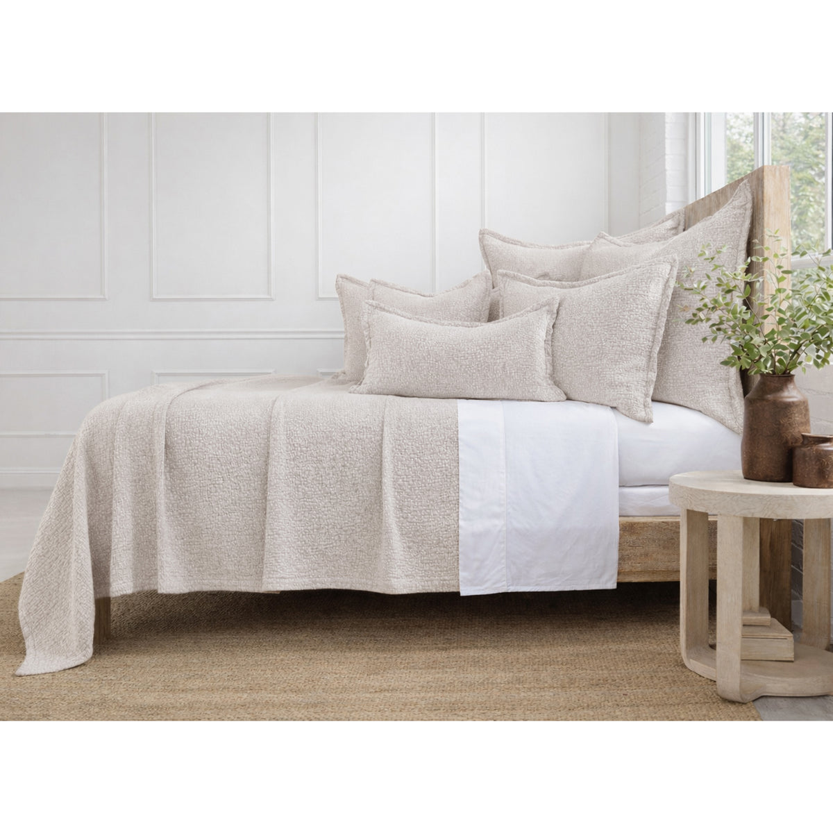 Oatmeal matelasse bed quilt with matching pillow shams, textured woven surface